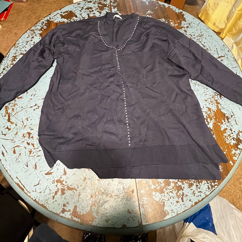 Simple blue sweater with beaded pearl-like design down middle.